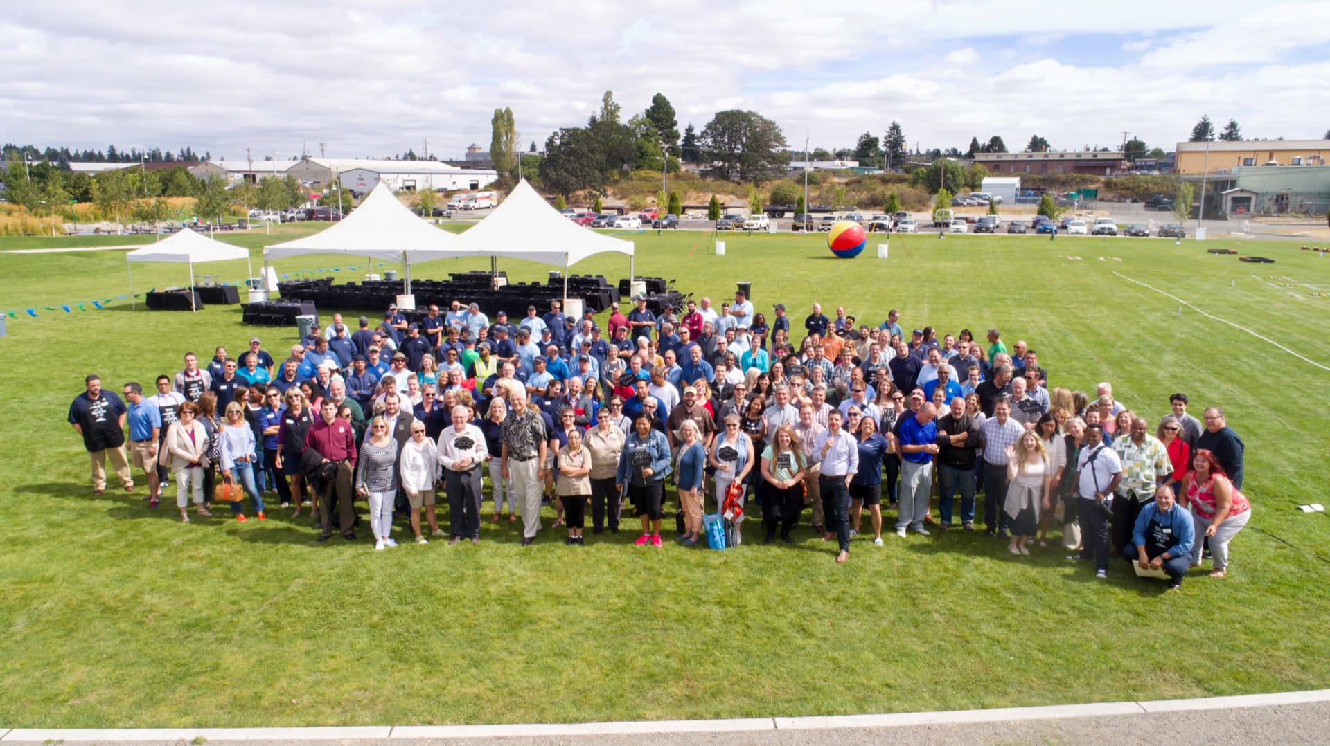 Lots of staff coordinated into a single aerial frame, captured in controlled airspace near an airport.